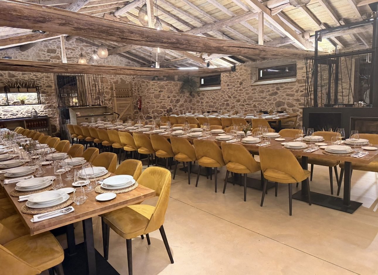 Close view of a banquet table laid beneath the timber roof