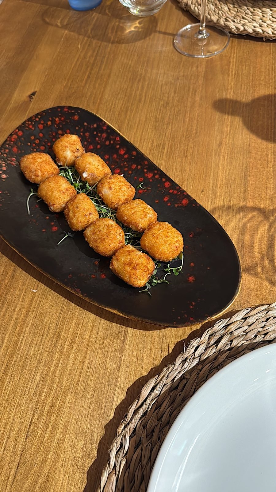 Ibérico ham croquettes served on a dark board